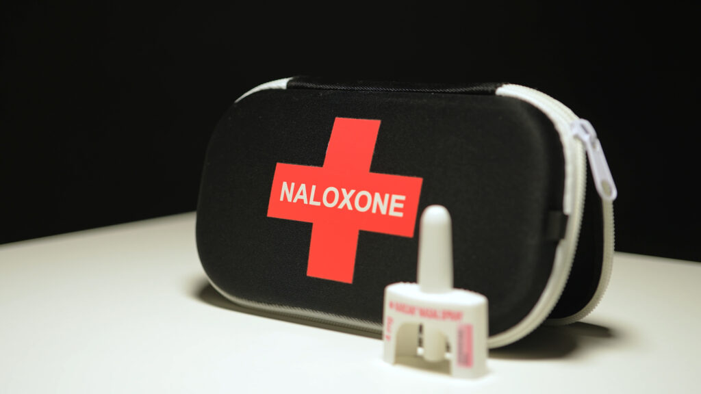 Naloxone and Narcan nasal spray in the emergency overdose kit bag used for recovery from narcotic opioid medications or street drugs overdose