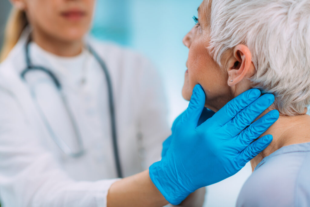 Thyroid gland control. Endocrinology doctor examining senior woman at a clinic.
