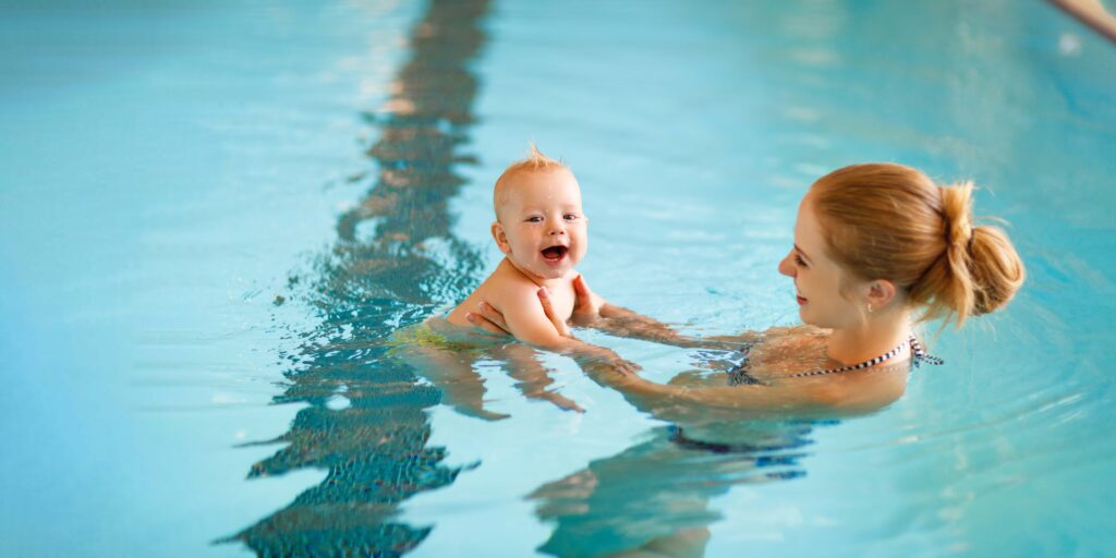 Mother and baby swim  in the pool