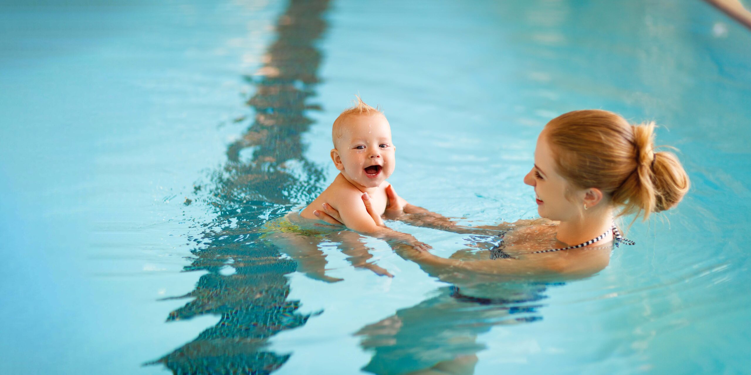 Mother and baby swim  in the pool