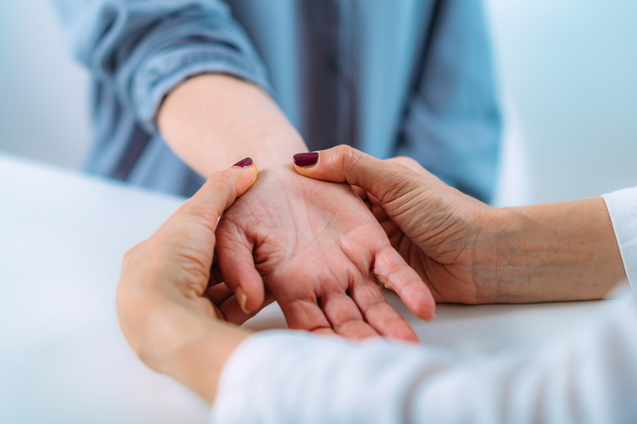 Examining the hand of a senior patient with carpal tunnel syndrome. Close-up image of senior woman’s wrist.