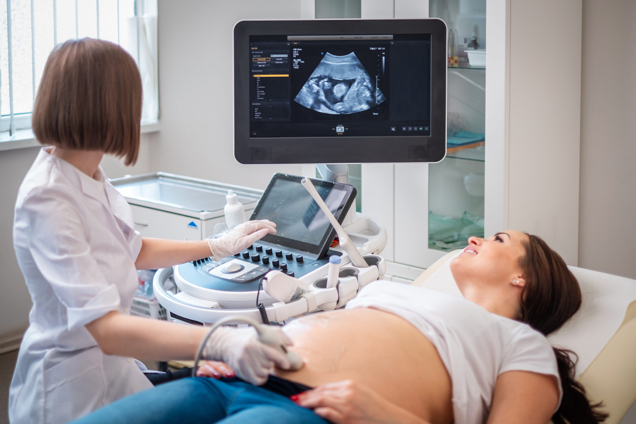 Pregnant woman on utltrasonographic examination at hospital.