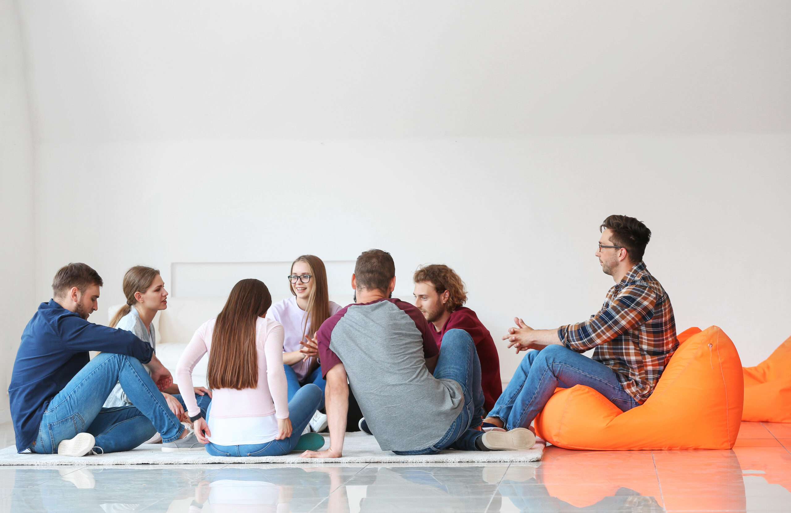 Young people with psychologist at group therapy session